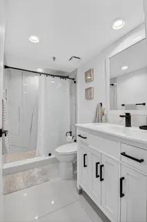 a view of a hallway with wooden floor and white walls