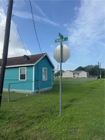a backyard of a house with table and chairs