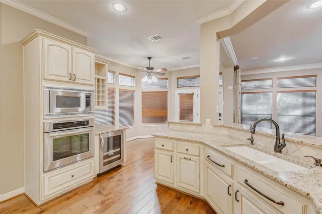 a kitchen with stainless steel appliances granite countertop a stove and a sink