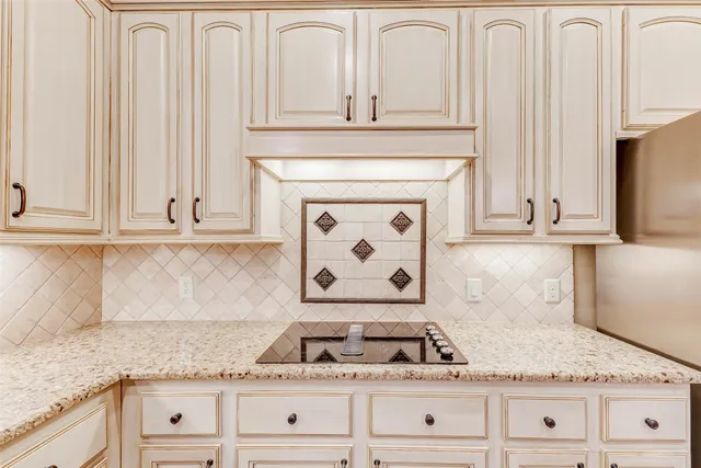 a kitchen with granite countertop white cabinets and white appliances