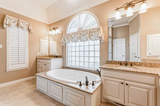 a spacious bathroom with a granite countertop tub sink and mirror