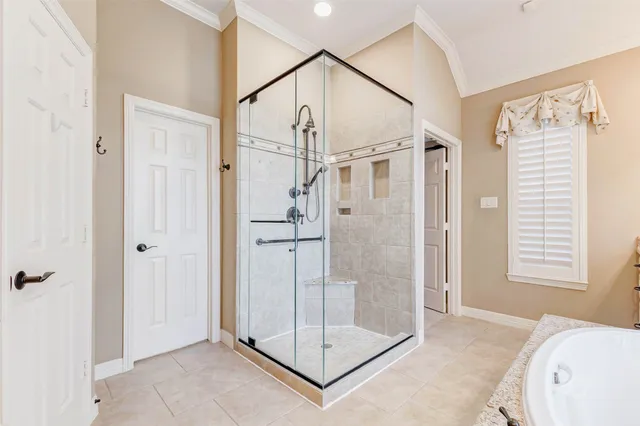 a view of a bathroom with a tub and shower