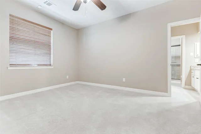 an empty room with windows and entrance