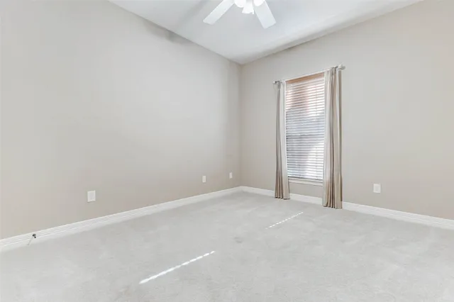 an empty room with a empty space and a ceiling fan
