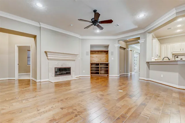 a view of an empty room with a fireplace and a window
