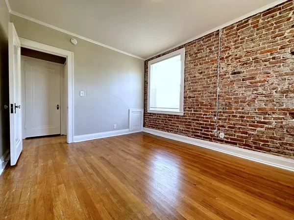 a view of an empty room and wooden floor