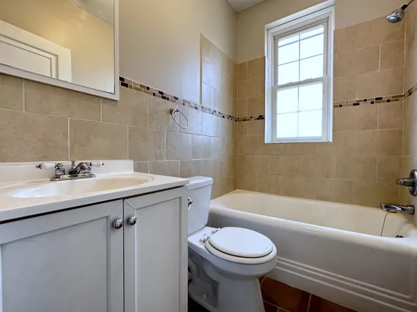 a bathroom with a sink a toilet and bathtub