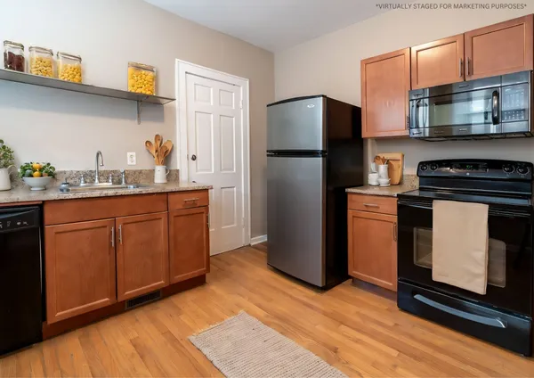 a kitchen with stainless steel appliances granite countertop a stove a refrigerator and a sink