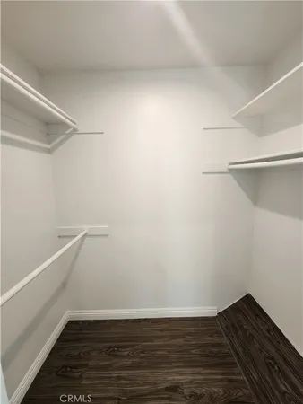 a room with wooden floor and white walls