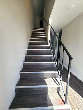 a view of kitchen with sink and refrigerator