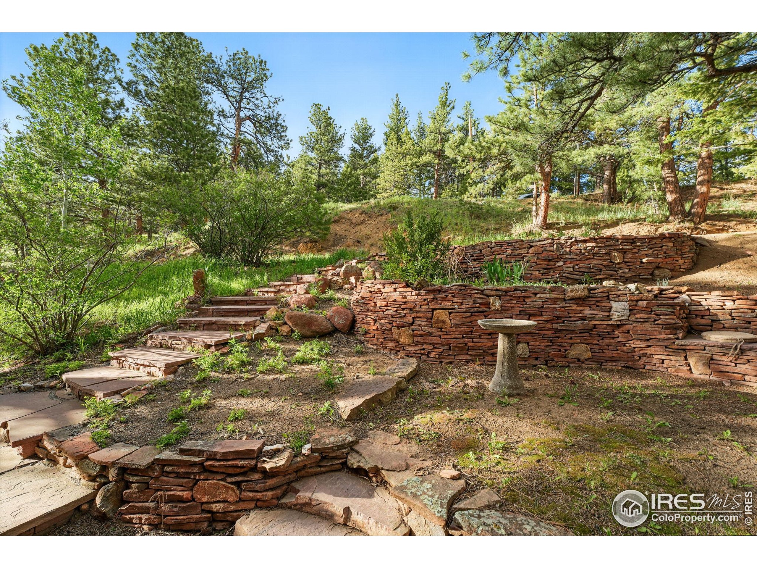 1101 Peakview Circle Boulder, CO 80302 - Photo 12 of 37 a backyard of a house with a yard and outdoor seating