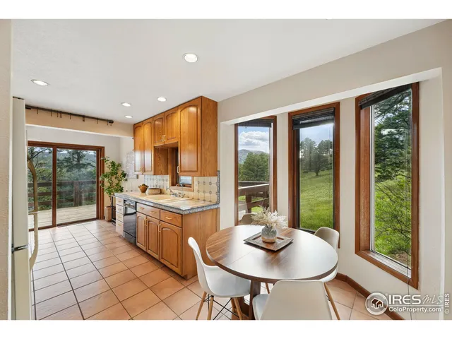 a view of a chairs and table on the deck
