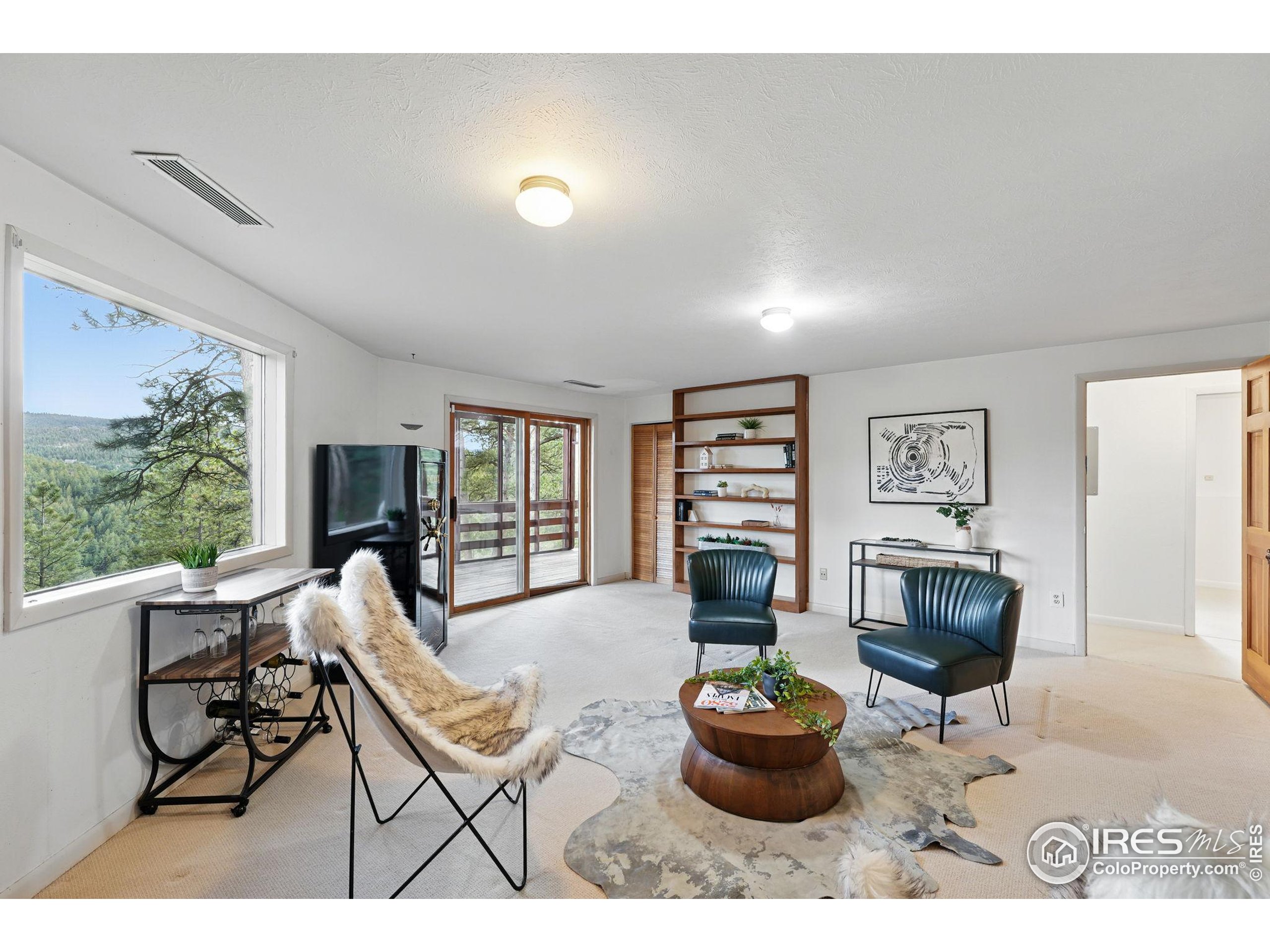 1101 Peakview Circle Boulder, CO 80302 - Photo 28 of 37 a living room with furniture and a wooden floor
