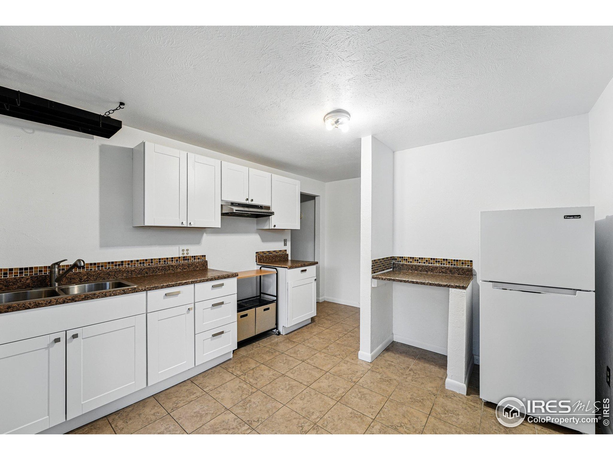 1101 Peakview Circle Boulder, CO 80302 - Photo 29 of 37 a kitchen with stainless steel appliances a refrigerator sink and cabinets