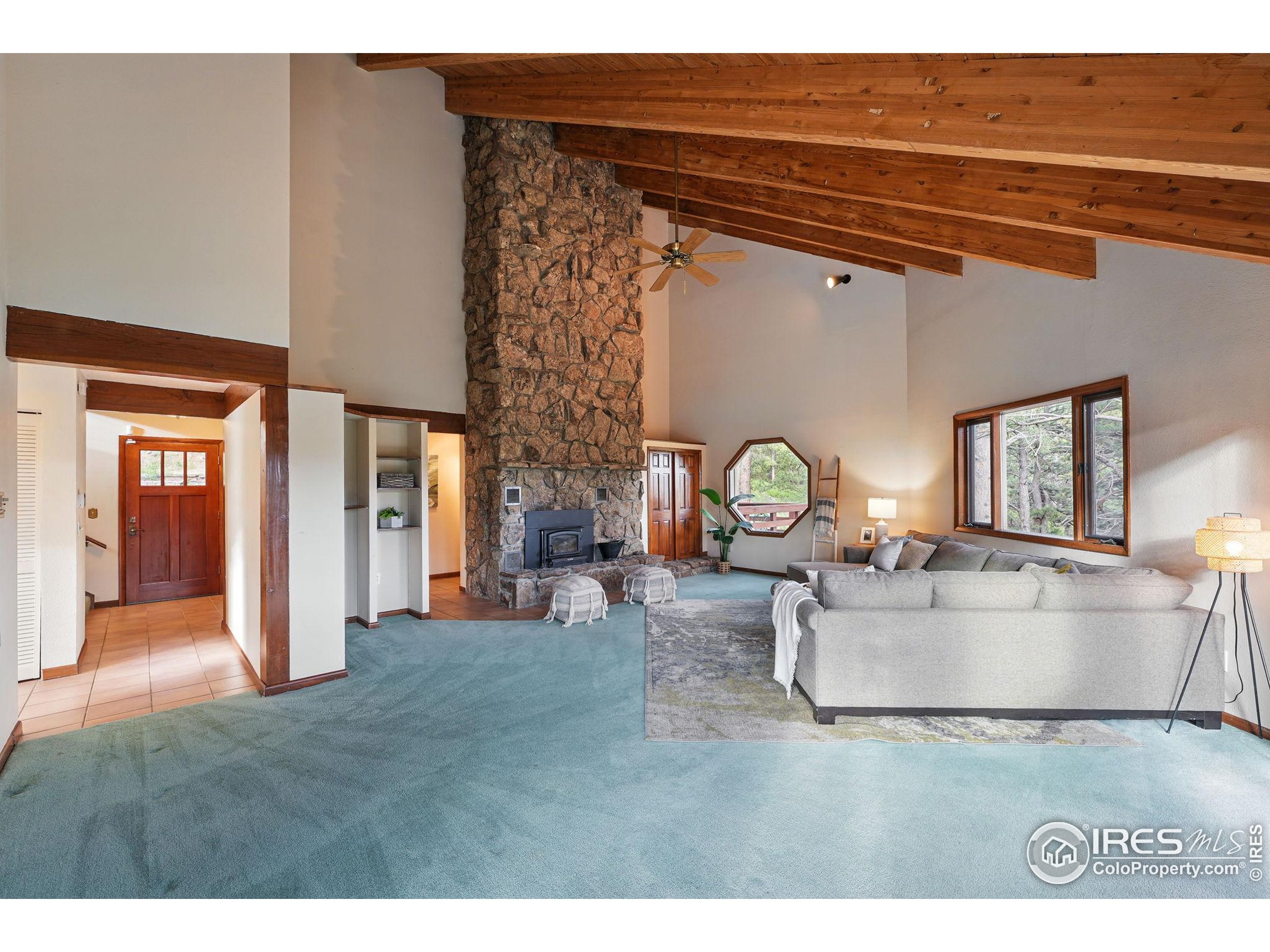 1101 Peakview Circle Boulder, CO 80302 - Photo 7 of 37 a living room with furniture a clock and a window