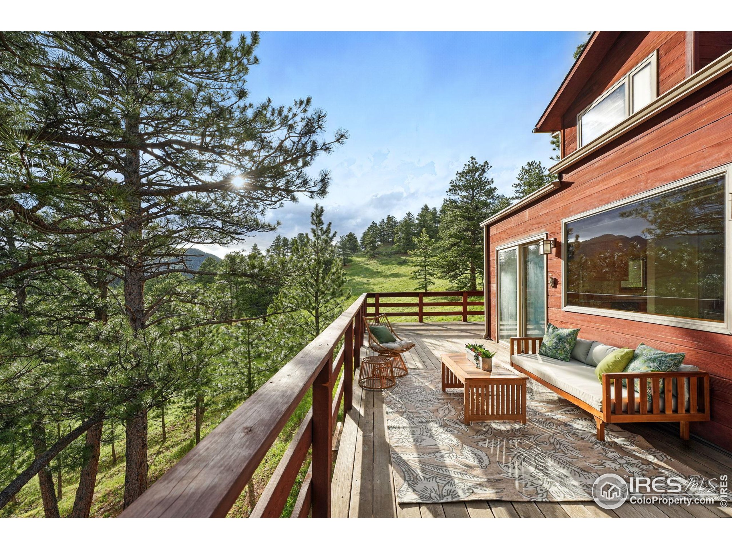 1101 Peakview Circle Boulder, CO 80302 - Photo 9 of 37 a balcony with wooden floor and outdoor seating