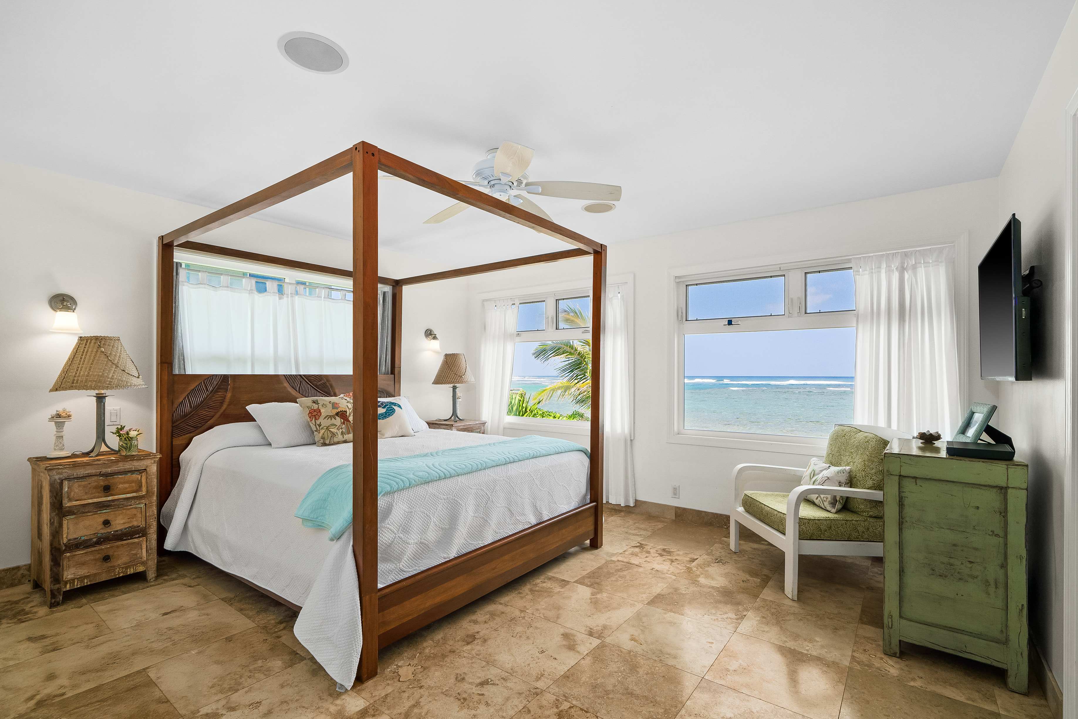 4910 Aliomanu Road Anahola, HI 96703 - Photo 11 of 30 a bedroom with a bed window and a flat screen tv