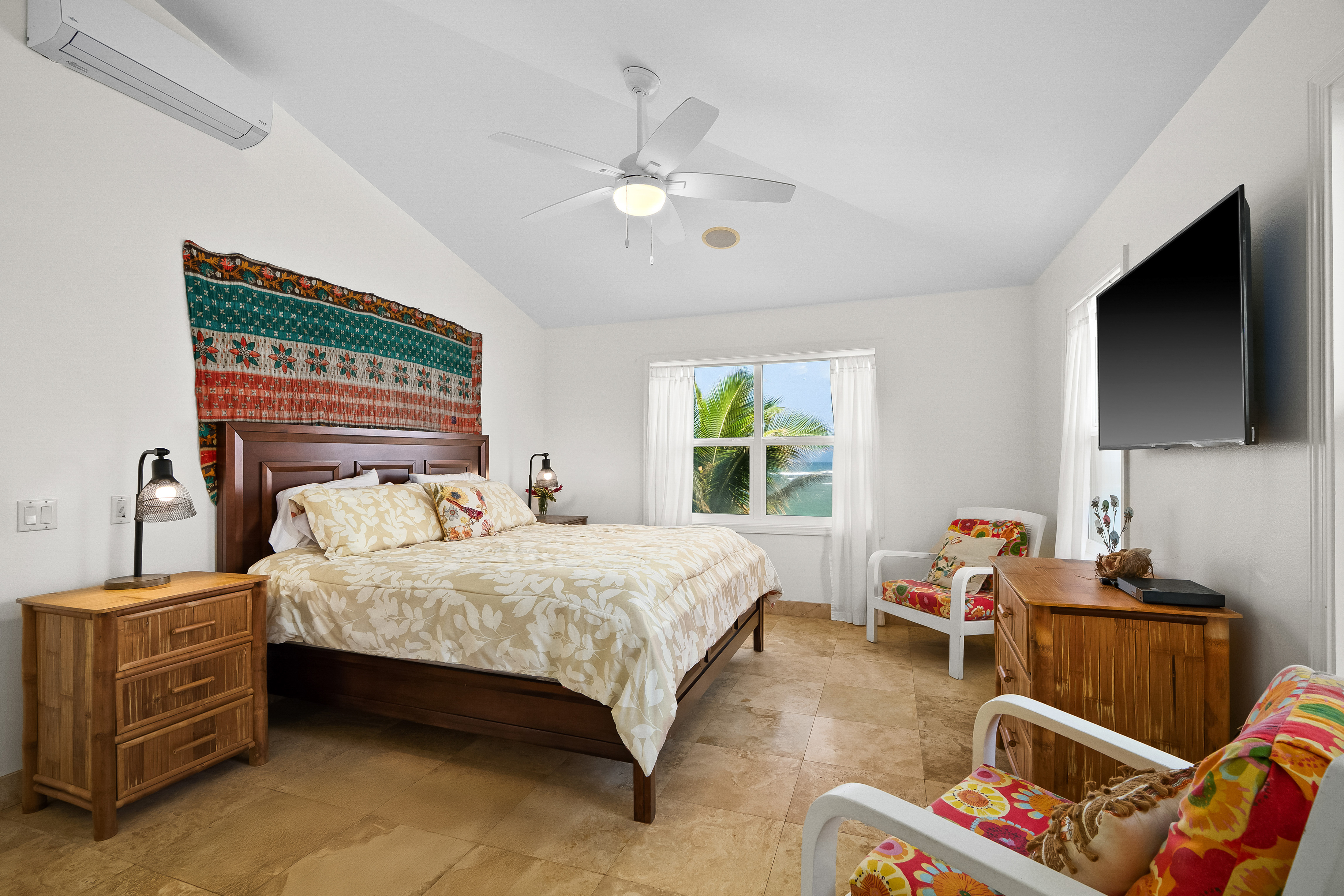 4910 Aliomanu Road Anahola, HI 96703 - Photo 15 of 30 a bedroom with a bed and a flat tv screen on dresser