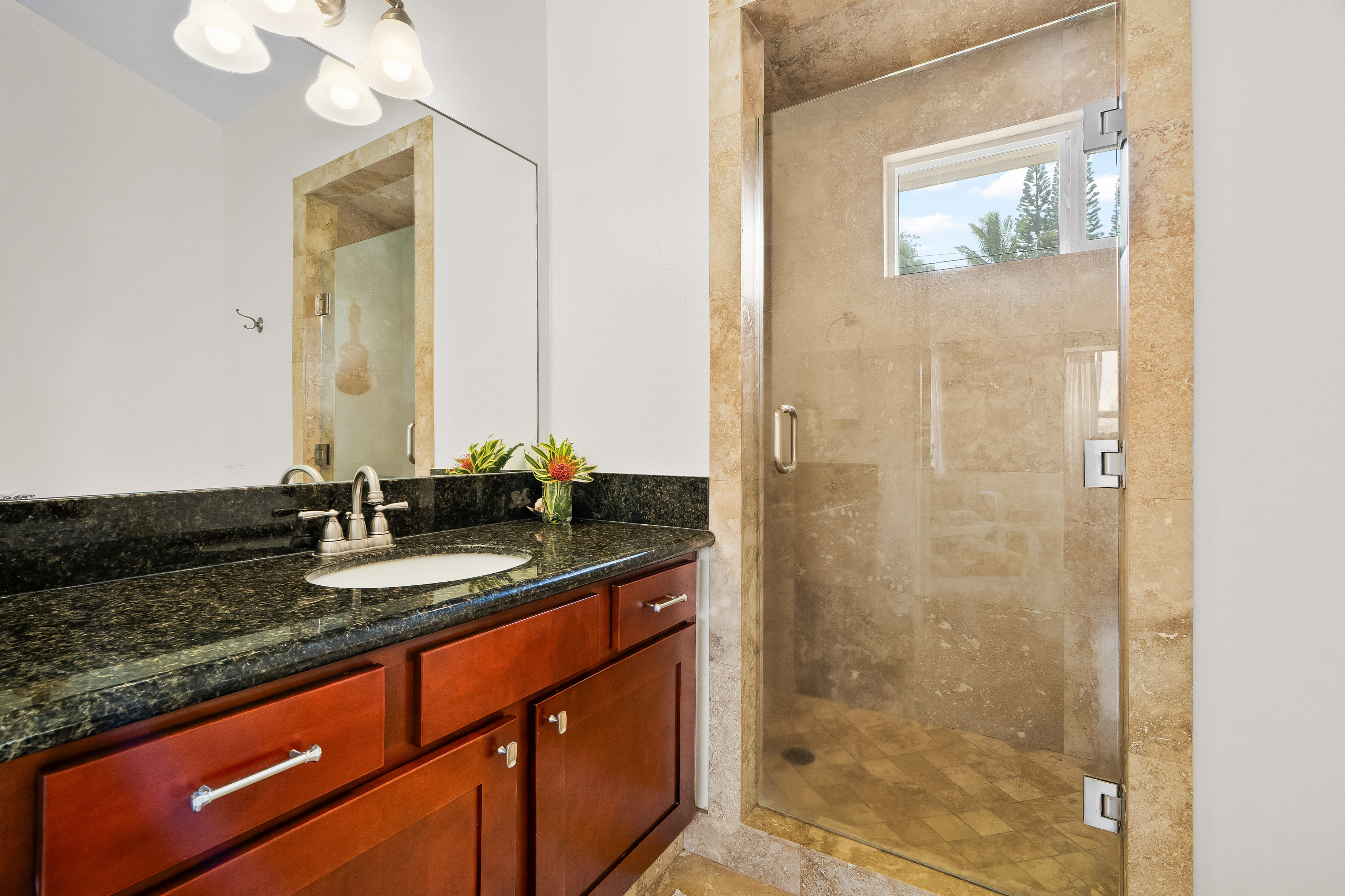 4910 Aliomanu Road Anahola, HI 96703 - Photo 18 of 30 a bathroom with a granite countertop sink a mirror and a shower