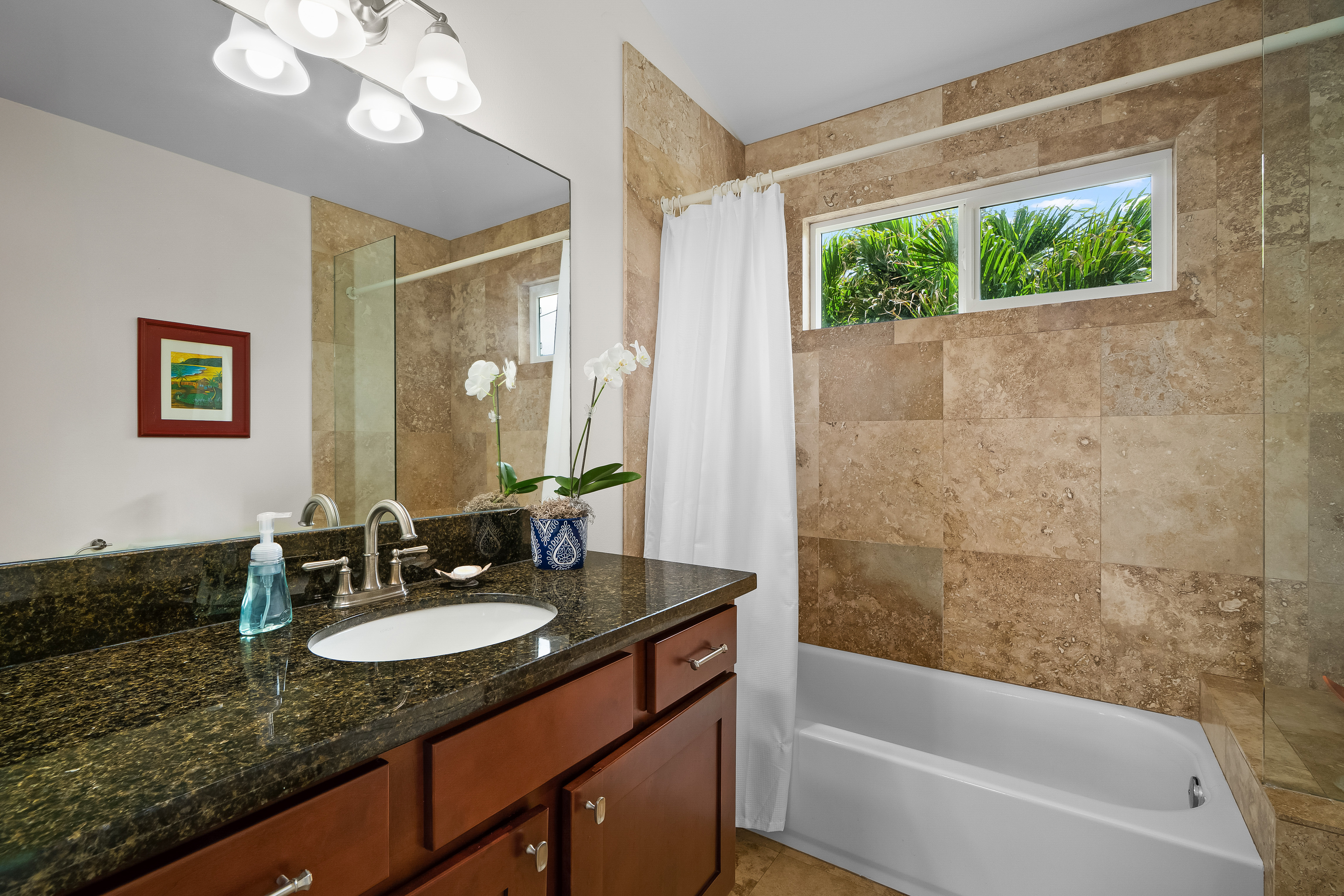 4910 Aliomanu Road Anahola, HI 96703 - Photo 21 of 30 a bathroom with a granite countertop sink a mirror a bathtub and shower