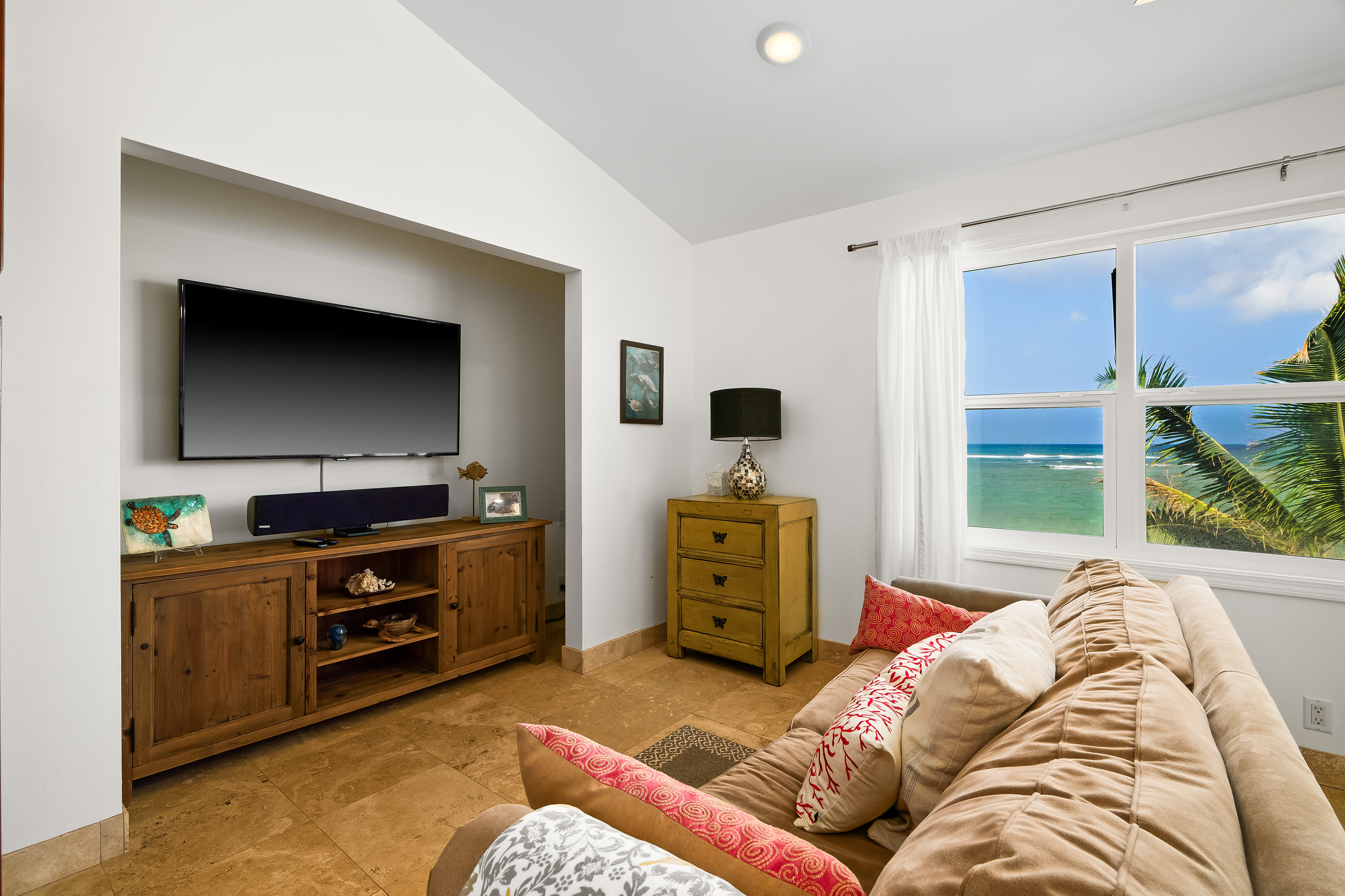 4910 Aliomanu Road Anahola, HI 96703 - Photo 24 of 30 a bedroom with furniture and a flat screen tv