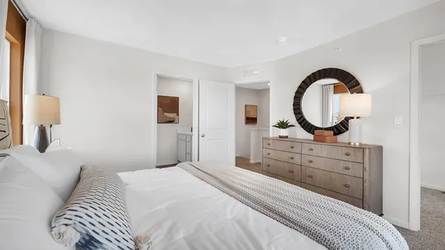 a bedroom with a bed and a dresser