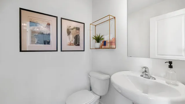 a white toilet sitting next to a bathroom sink