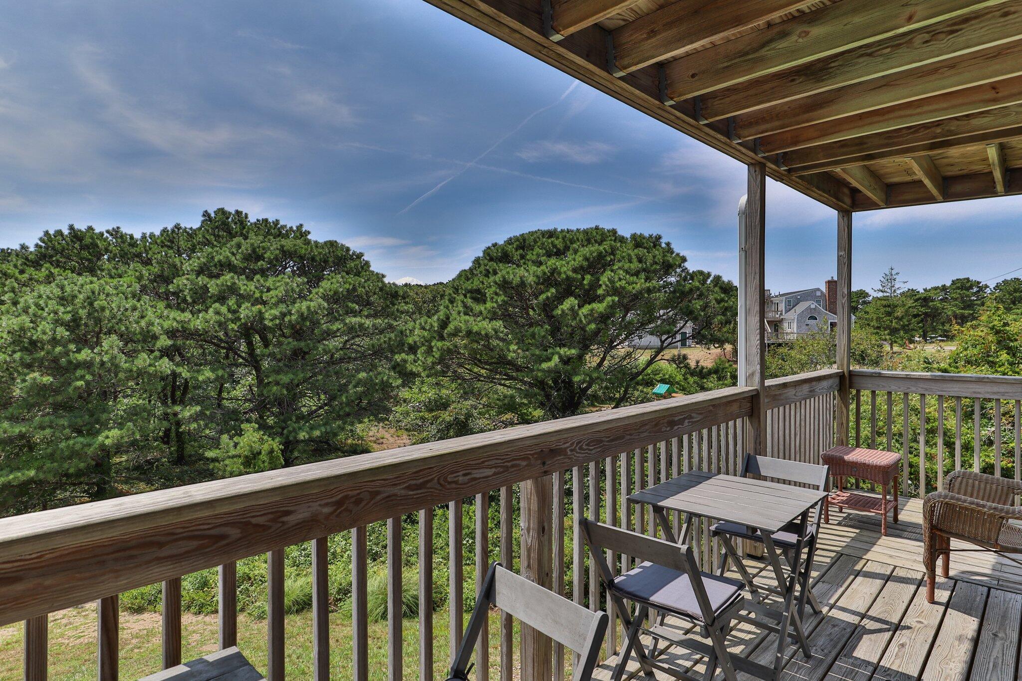 132 Shore Road, Unit 31 Truro, MA 02666 - Photo 11 of 24 a view of a balcony with chairs and wooden fence