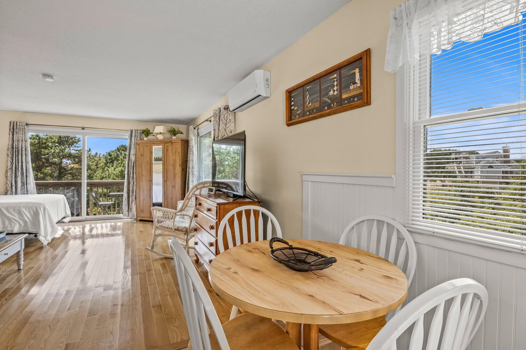 132 Shore Road, Unit 31 Truro, MA 02666 - Photo 15 of 24 a dining room with furniture and wooden floor