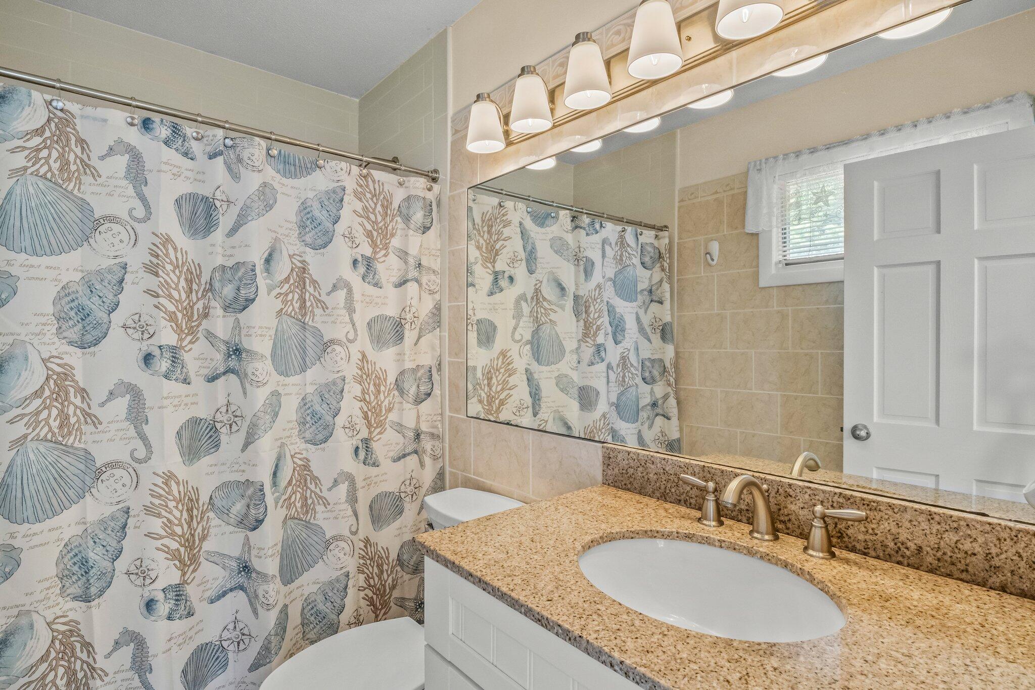 132 Shore Road, Unit 31 Truro, MA 02666 - Photo 18 of 24 a bathroom with a granite countertop sink and a mirror