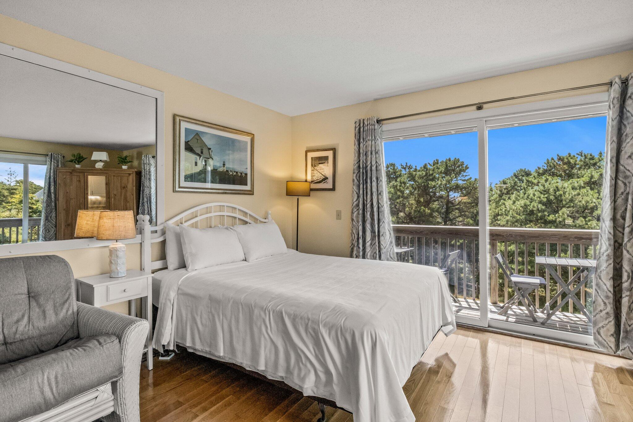 132 Shore Road, Unit 31 Truro, MA 02666 - Photo 7 of 24 a bedroom with a large bed and a large window