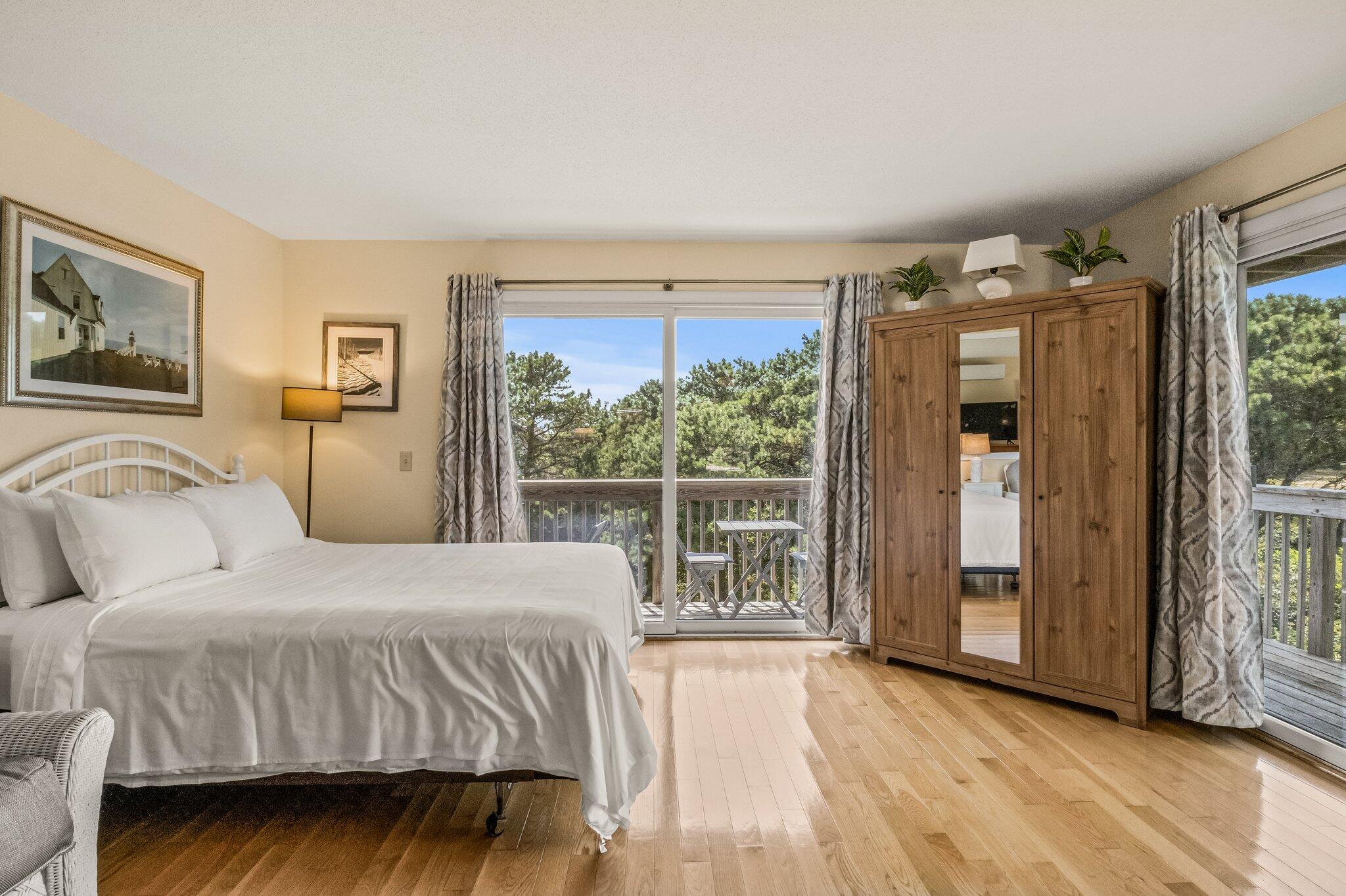 132 Shore Road, Unit 31 Truro, MA 02666 - Photo 8 of 24 a bedroom with a large bed and a large window