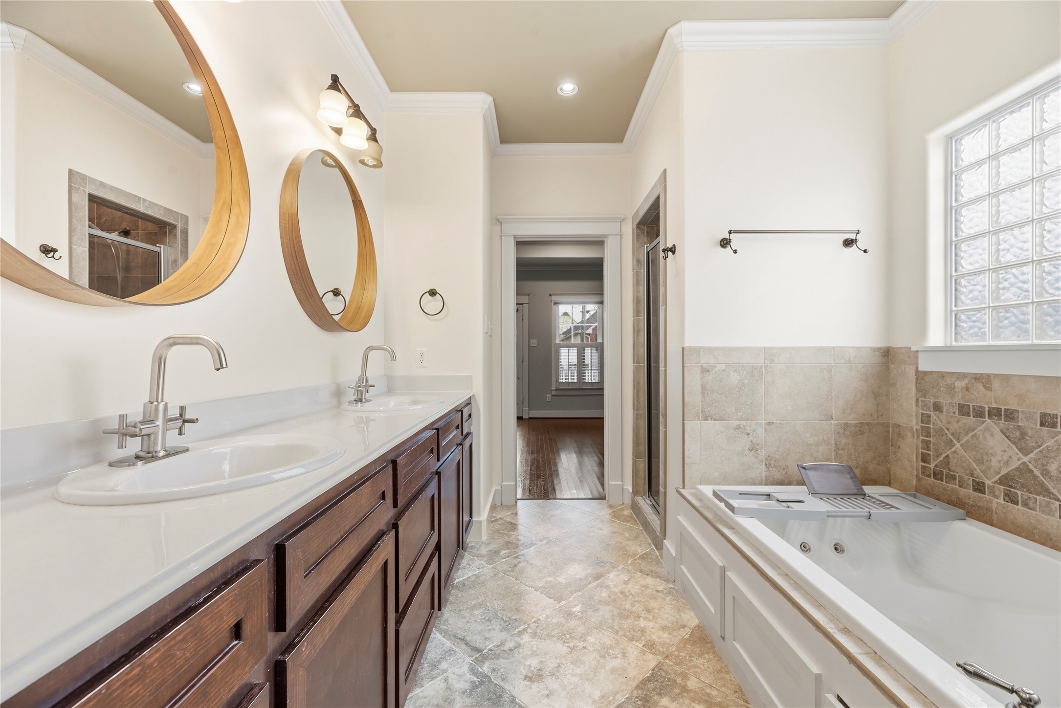 1505 Prince Street Houston, TX 77008 - Photo 22 of 39 The primary bath showcases rich cabinetry and double sinks, alongside a jetted soaking tub and a separate walk-in shower.