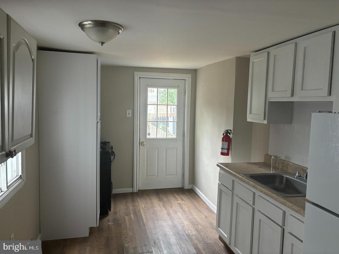 334 Middlesex Street Gloucester City, NJ 08030 - Photo 2 of 12 a kitchen with sink cabinets and wooden floor
