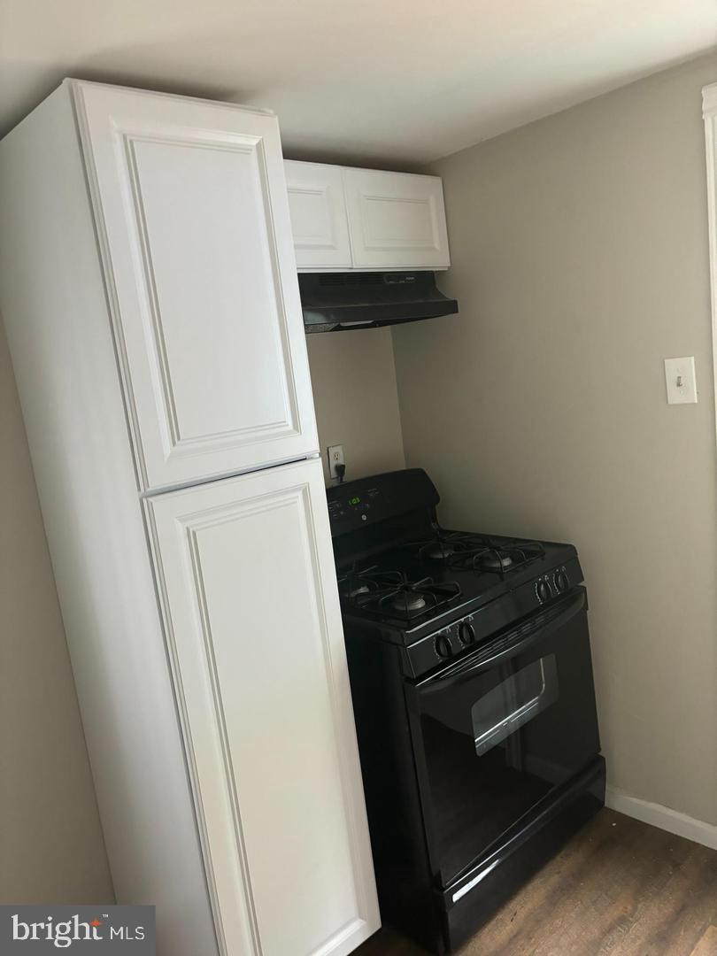 334 Middlesex Street Gloucester City, NJ 08030 - Photo 4 of 12 a stove top oven sitting inside of a kitchen