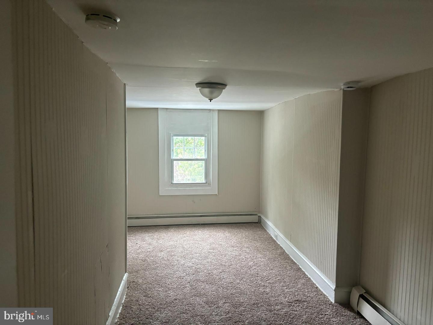 334 Middlesex Street Gloucester City, NJ 08030 - Photo 8 of 12 an empty room with cabinet and windows