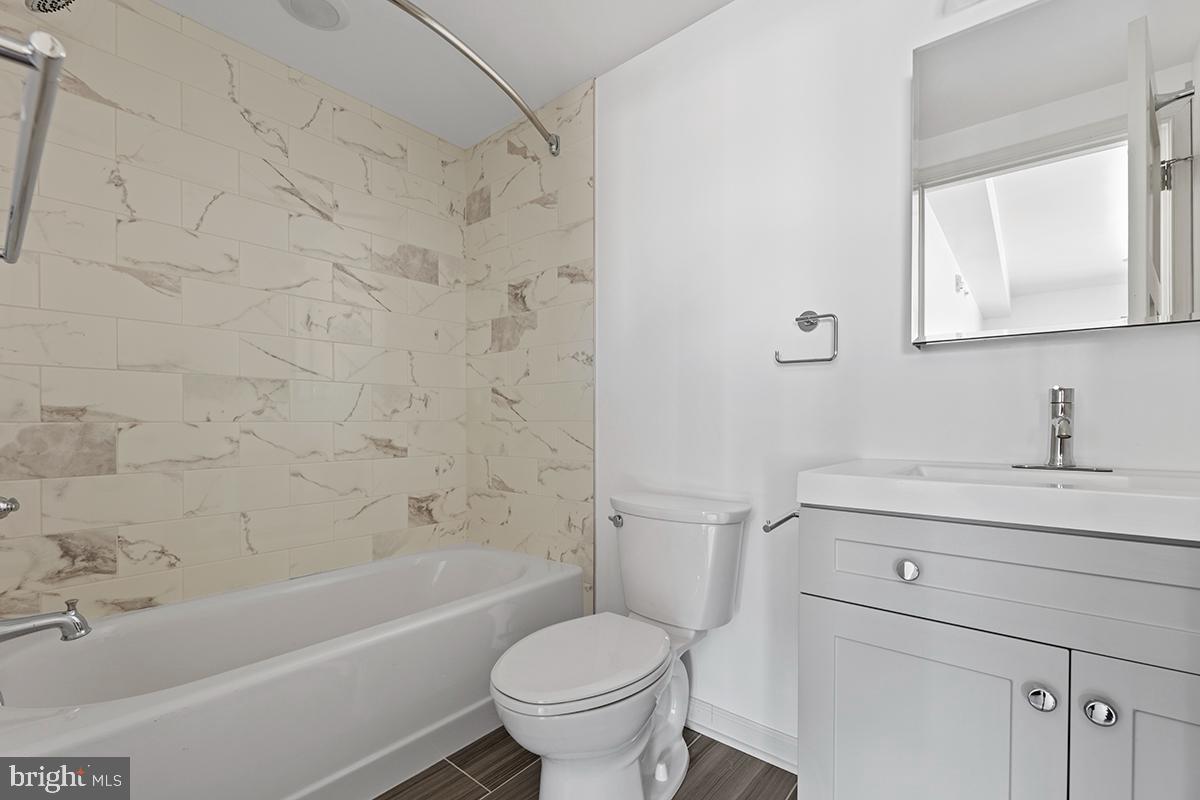 404 Fountain Street, Unit 208 Philadelphia, PA 19128 - Photo 6 of 8 a bathroom with a sink toilet and bathtub