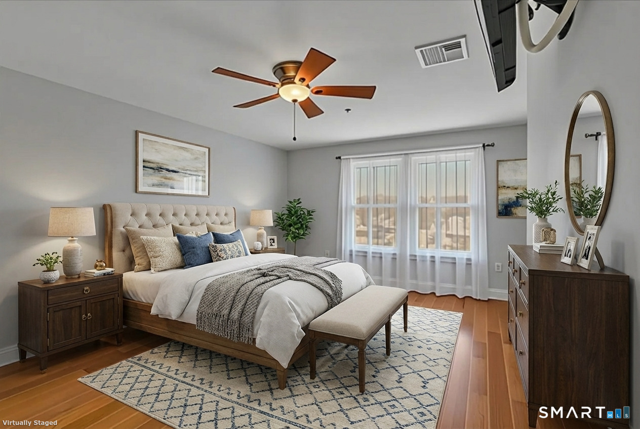 461 Bank Street, Unit 606 New London, CT 06320 - Photo 14 of 35 a bedroom with a large bed and a chandelier