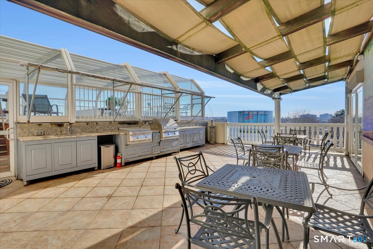 461 Bank Street, Unit 606 New London, CT 06320 - Photo 34 of 37 Outdoor kitchen with barbecue grill area and al fresco seating.