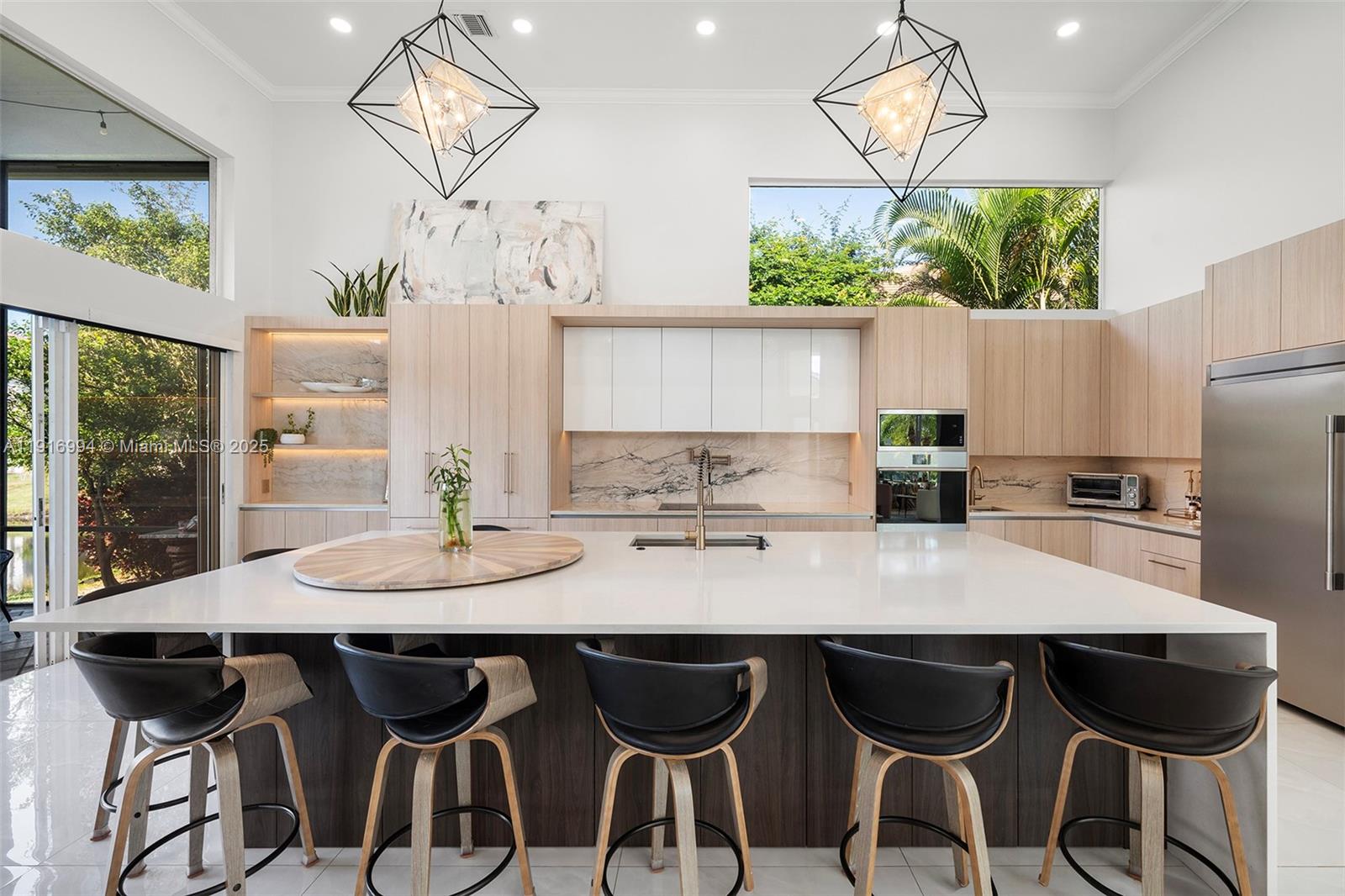 6451 Northwest 32nd Way Boca Raton, FL 33496 - Photo 19 of 54 a kitchen with granite countertop a table and chairs in it