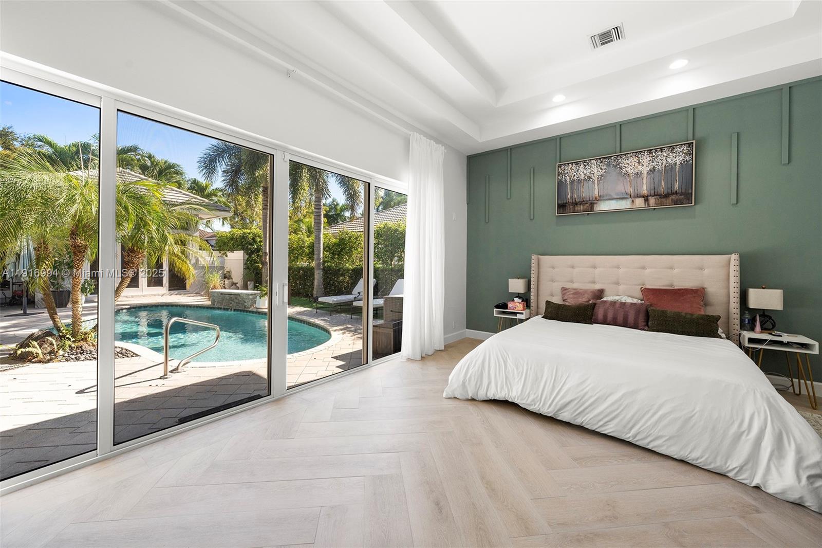 6451 Northwest 32nd Way Boca Raton, FL 33496 - Photo 24 of 54 a bedroom with a large bed and a large window