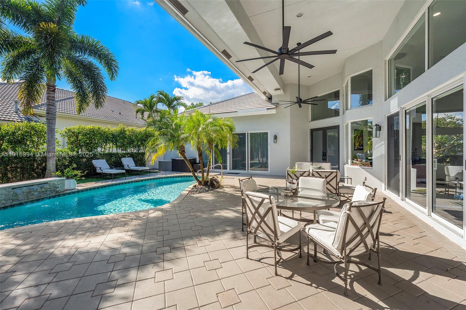 6451 Northwest 32nd Way Boca Raton, FL 33496 - Photo 25 of 54 a view of a patio with a table and chairs