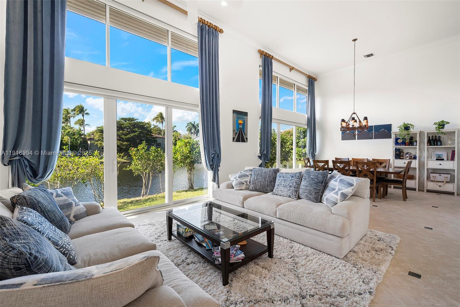6451 Northwest 32nd Way Boca Raton, FL 33496 - Photo 30 of 54 a living room with furniture and a large window