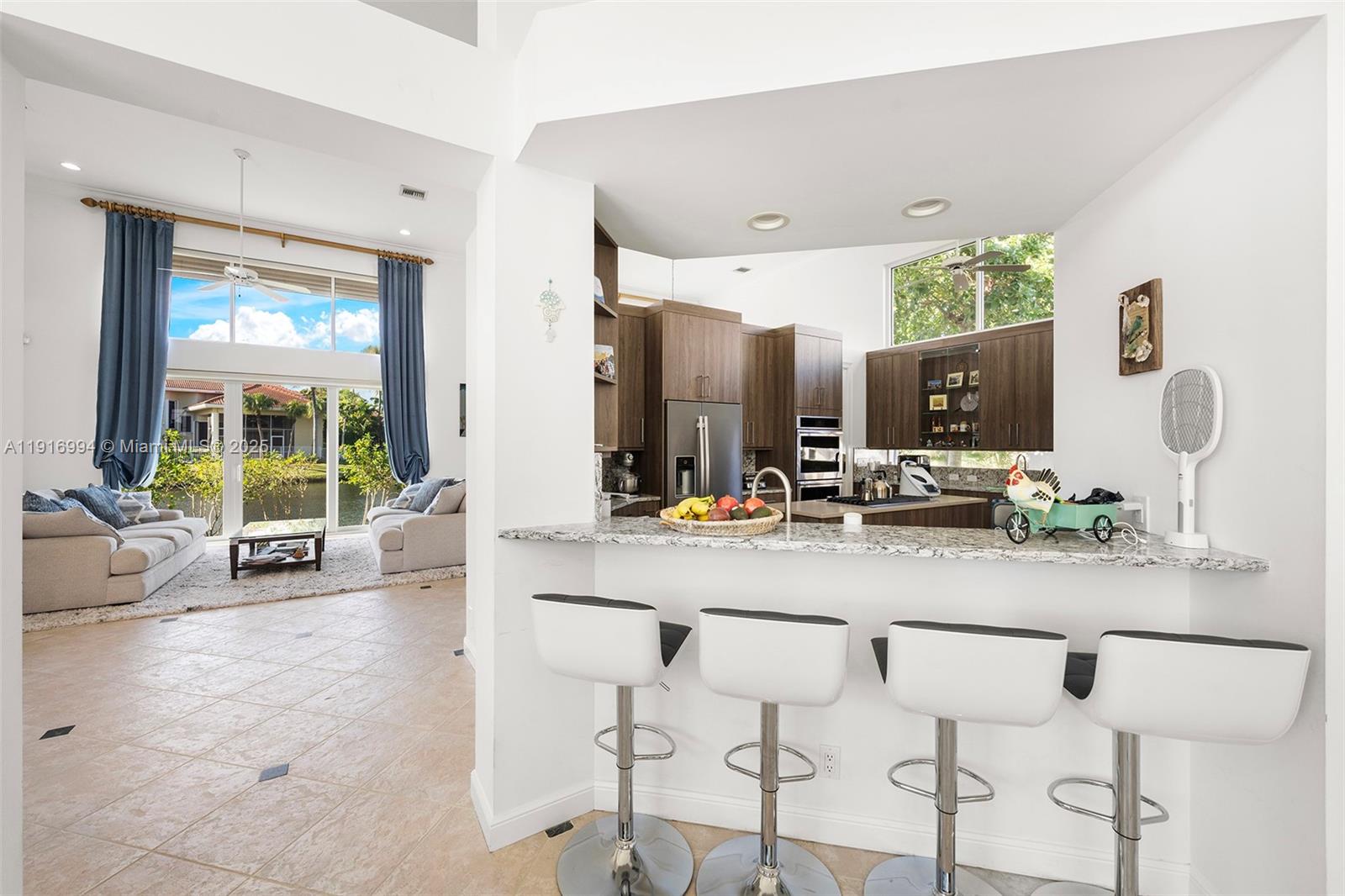 6451 Northwest 32nd Way Boca Raton, FL 33496 - Photo 35 of 54 a view of a lobby with furniture and floor to ceiling window