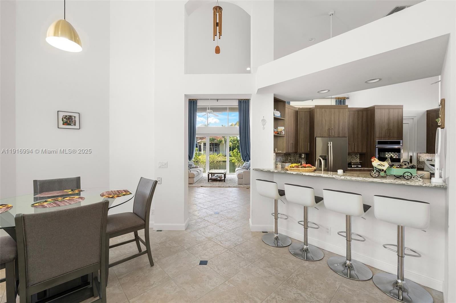 6451 Northwest 32nd Way Boca Raton, FL 33496 - Photo 36 of 54 a living room with furniture and a table