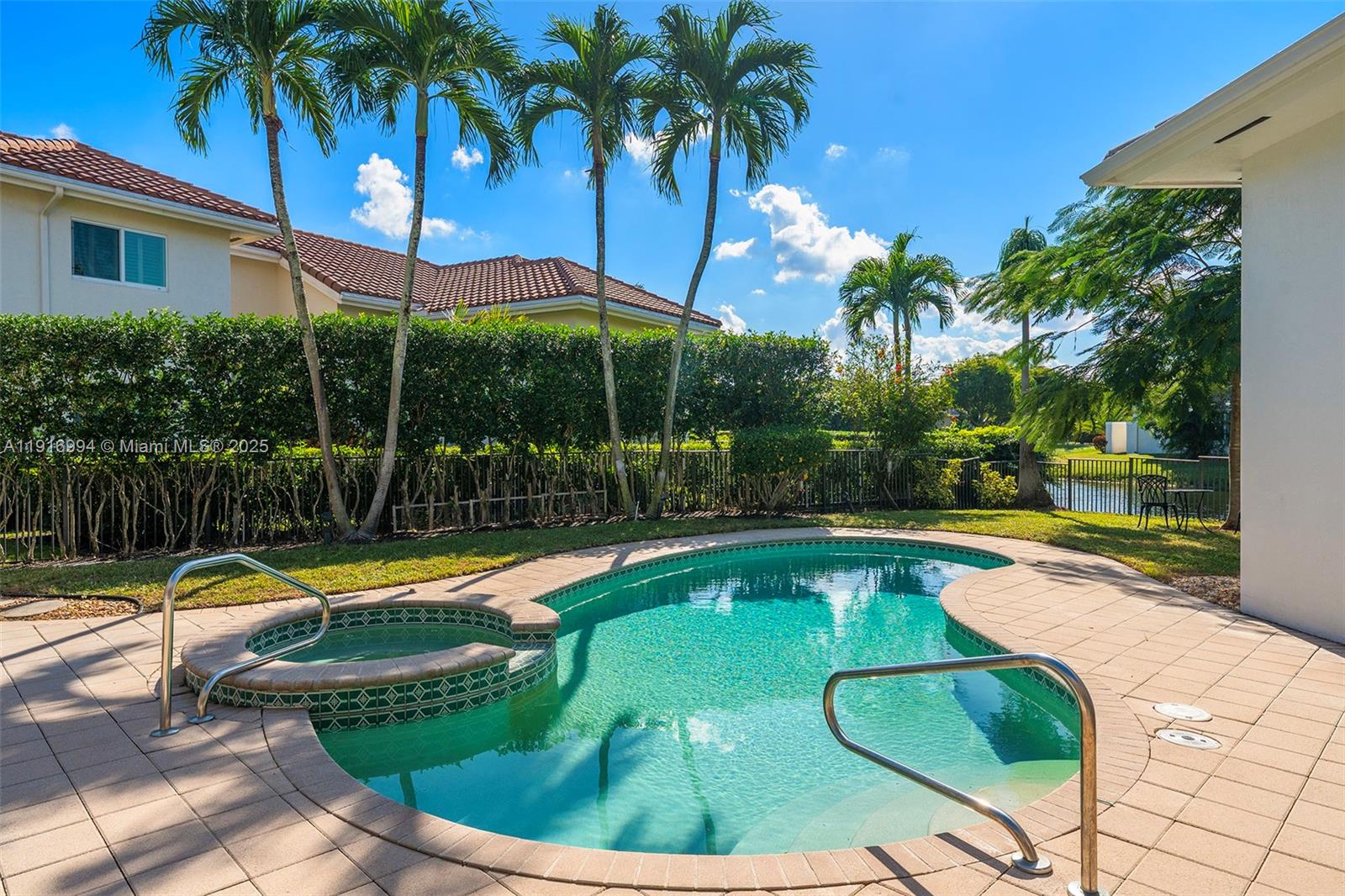 6451 Northwest 32nd Way Boca Raton, FL 33496 - Photo 41 of 54 a view of a swimming pool with a patio and a garden