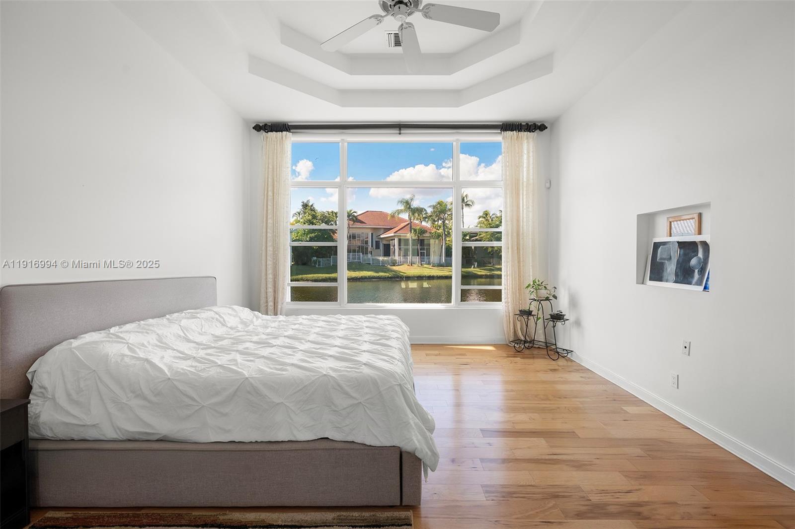 6451 Northwest 32nd Way Boca Raton, FL 33496 - Photo 48 of 54 a large bed sitting in a bedroom next to a window