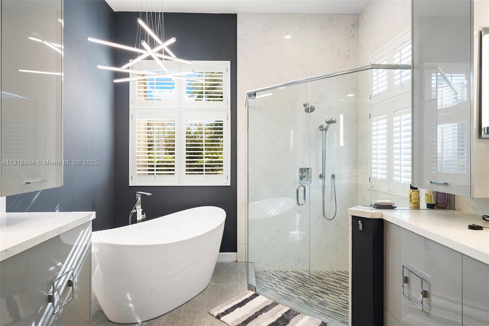 6451 Northwest 32nd Way Boca Raton, FL 33496 - Photo 50 of 54 a bathroom with a bathtub and a shower