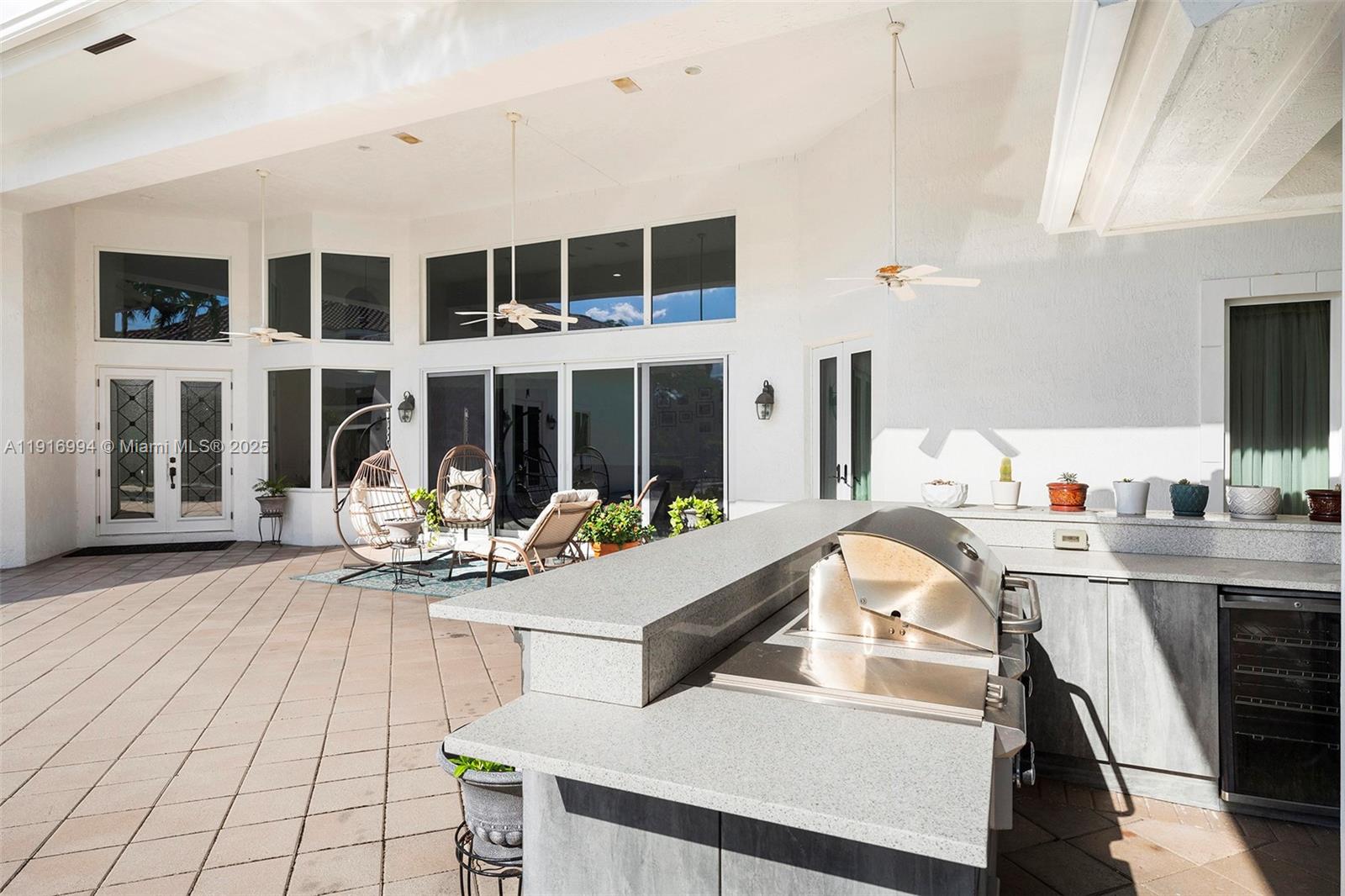 6451 Northwest 32nd Way Boca Raton, FL 33496 - Photo 51 of 54 a living room with furniture a flat screen tv and floor to ceiling window