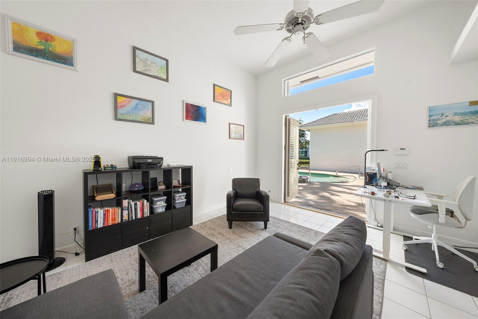 6451 Northwest 32nd Way Boca Raton, FL 33496 - Photo 53 of 54 a living room with furniture and a book shelf